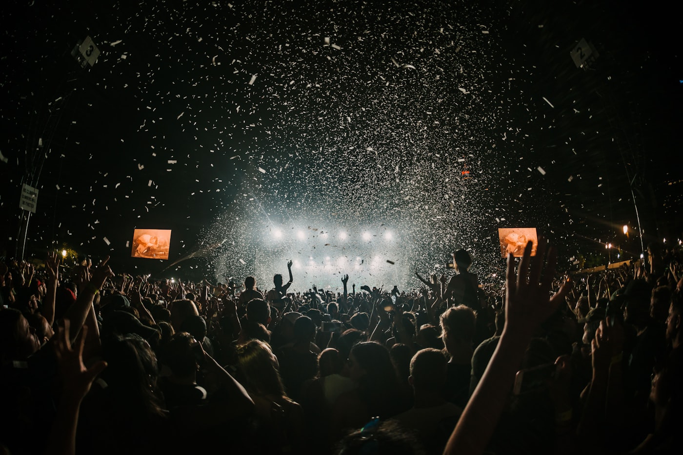 Nighttime outdoor festival crowd and stage lights